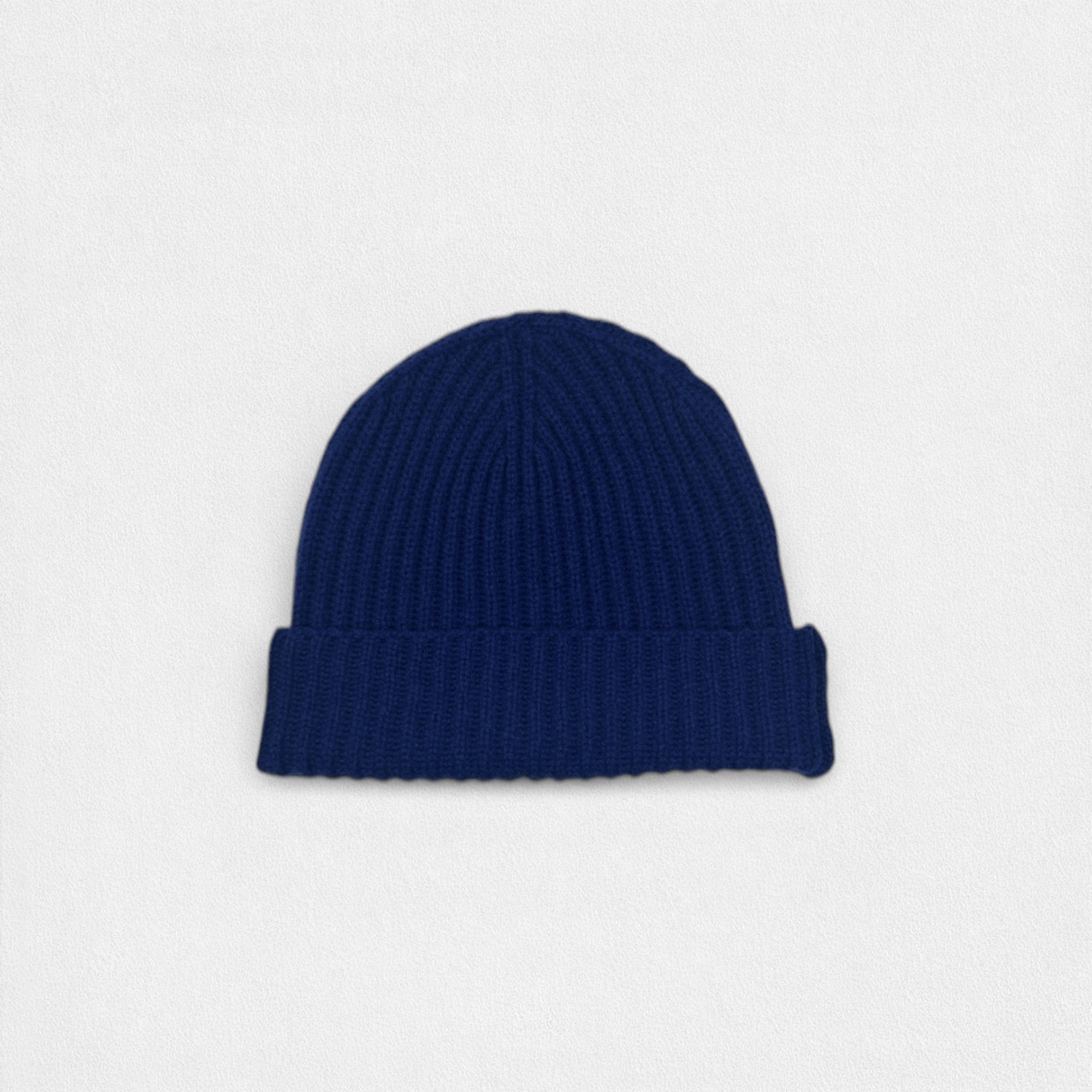 Blue knit beanie on a light gray background