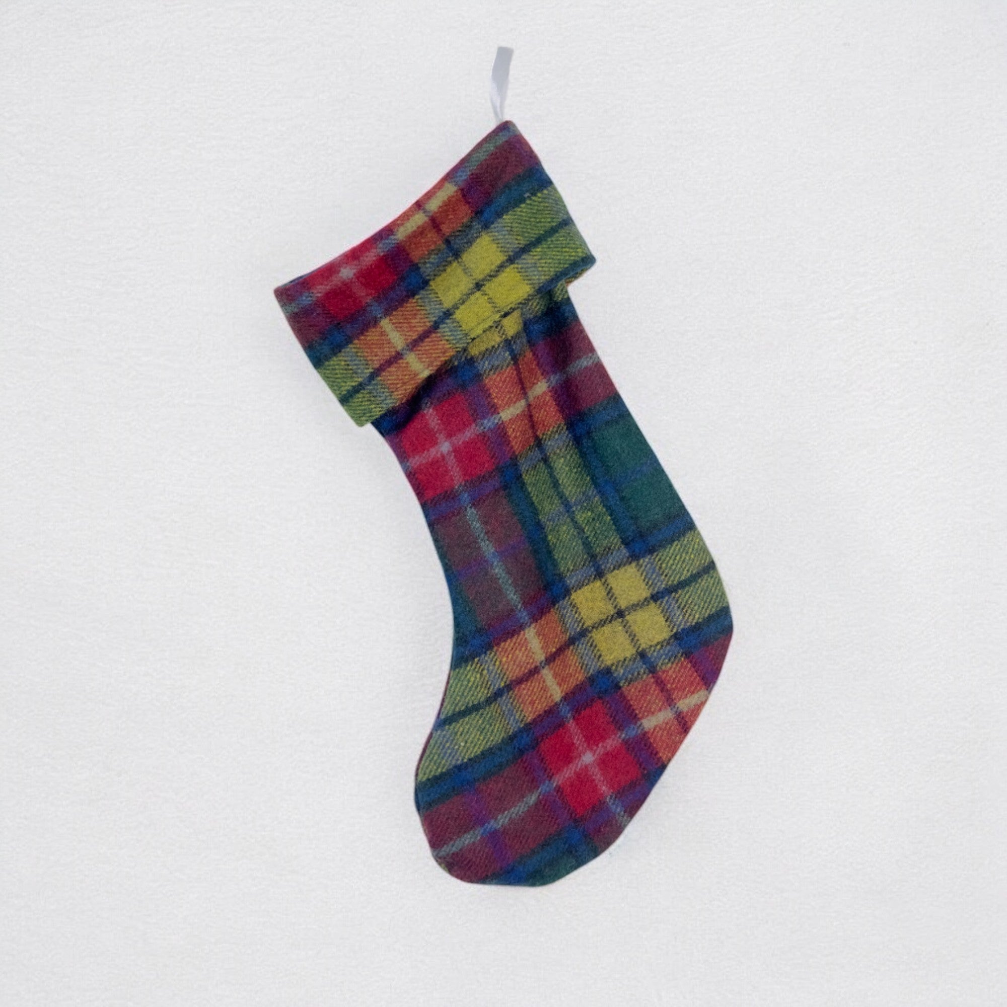The Buchanan Modern 100% wool Christmas Stocking hanging from a hook on a white background.