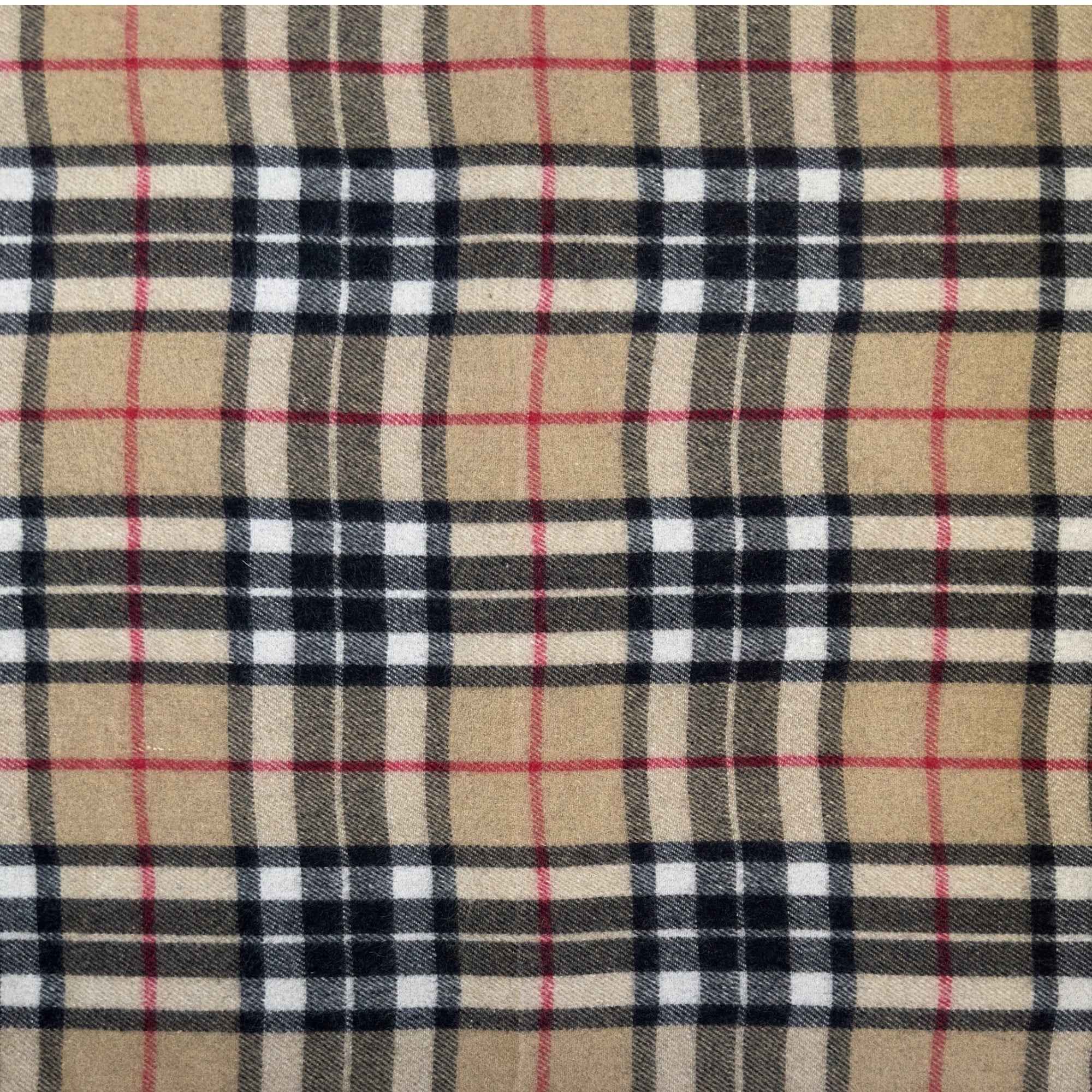 A close up of the Camel Thomson tartan, the Camel Thomson tartan has sand, black, white and red colors in a checkered pattern.
