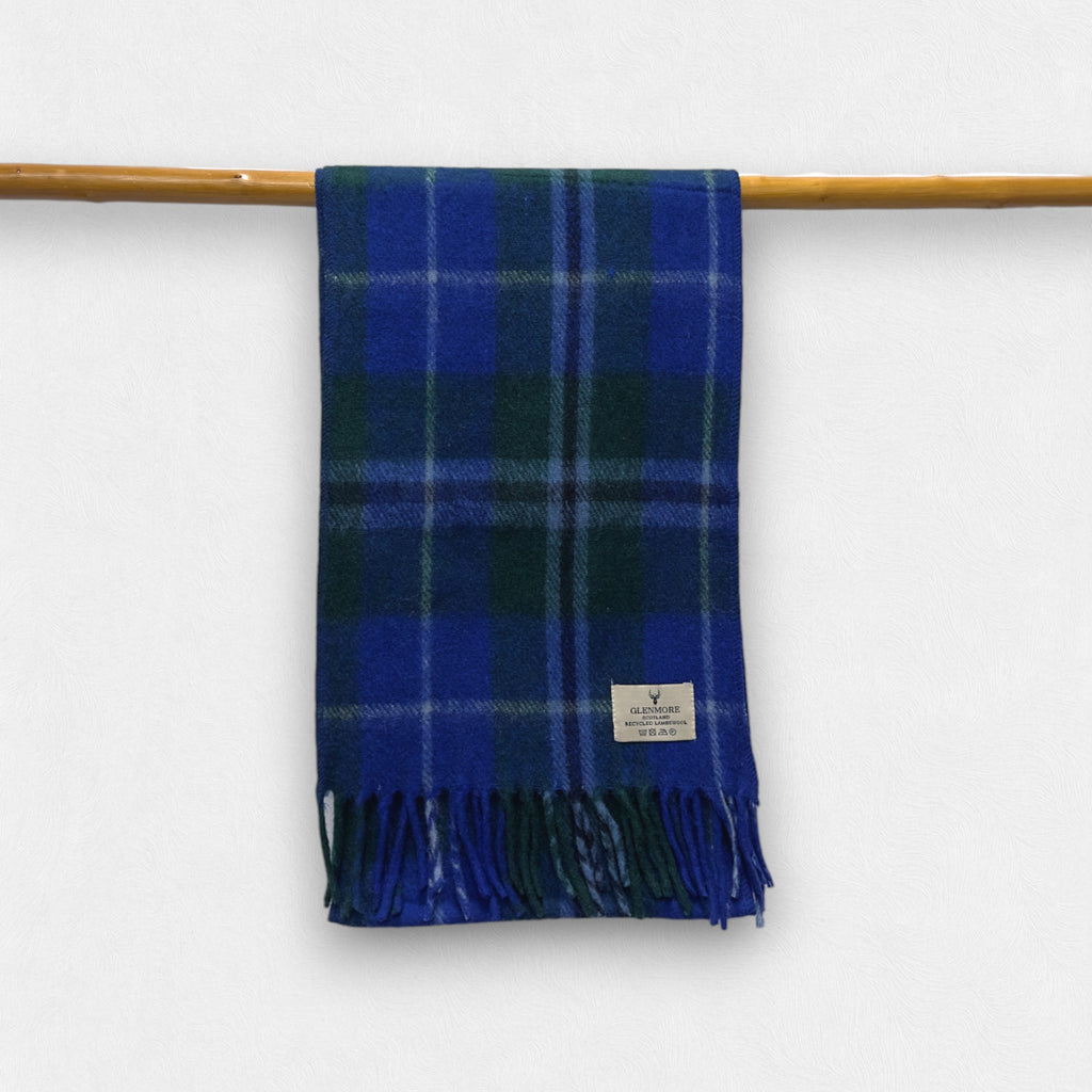 A douglas tartan checkered scarf with fringes displayed on a wooden rod.