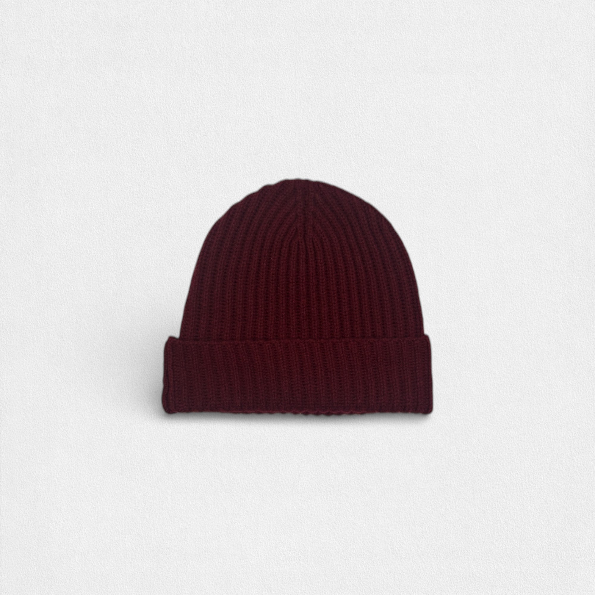 Maroon knit beanie on a light gray background