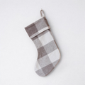 The Jacob tartan 100% wool Christmas stocking hanging against a plain background.