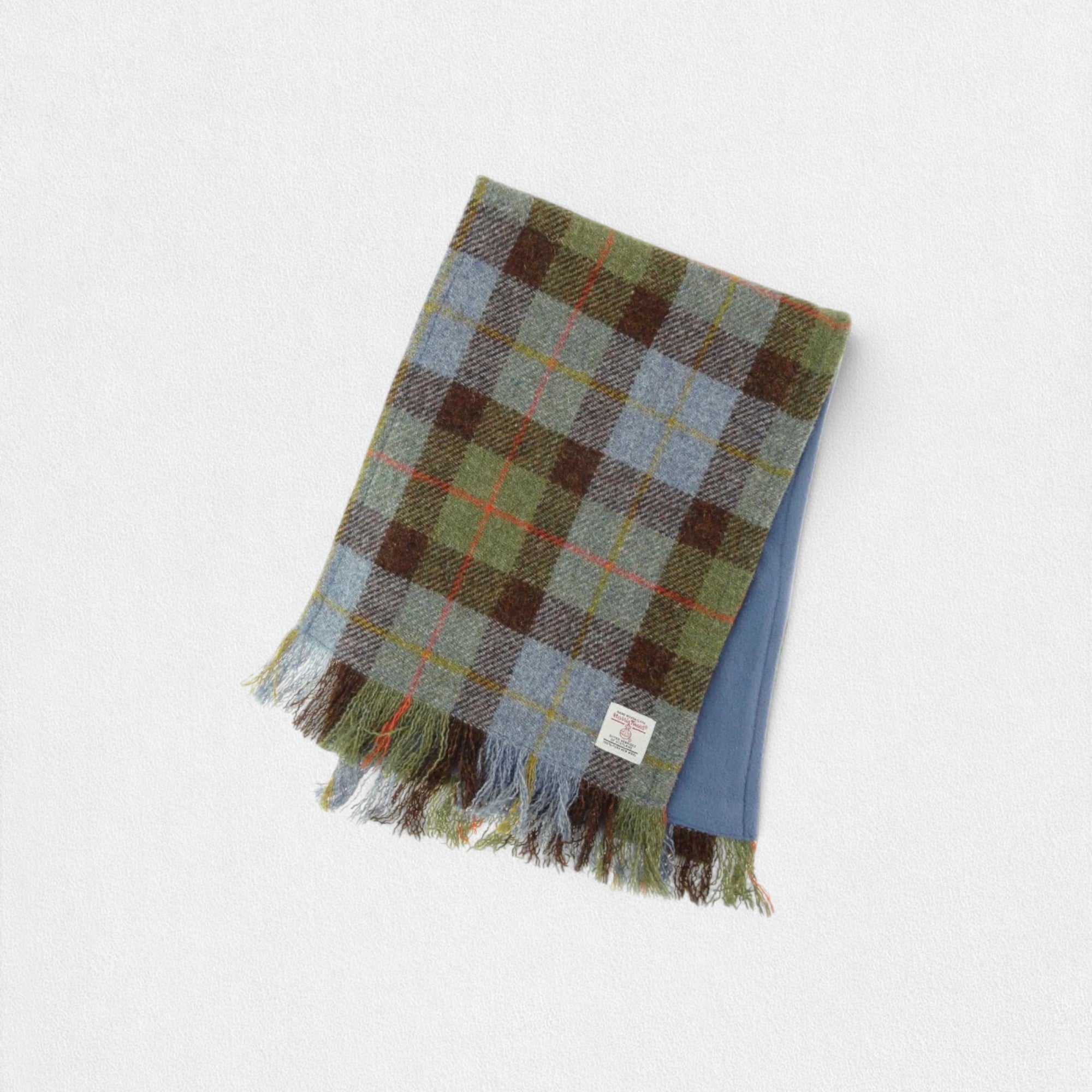 A scarf with a yellow and black MacLeod tartan pattern, backed with blue fleece, laid flat against a white background.