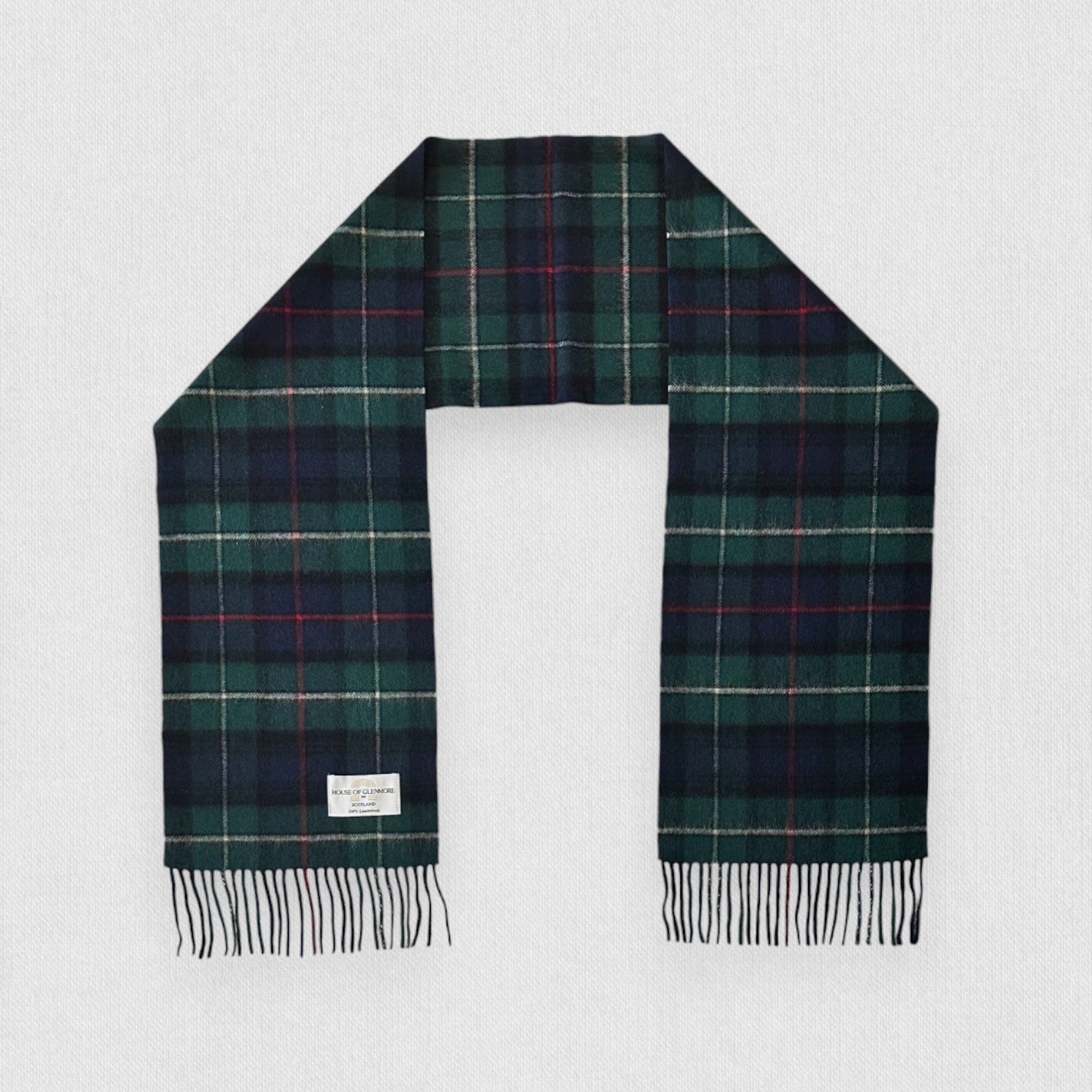 MacKenzie tartan scarf with fringes on a light gray background