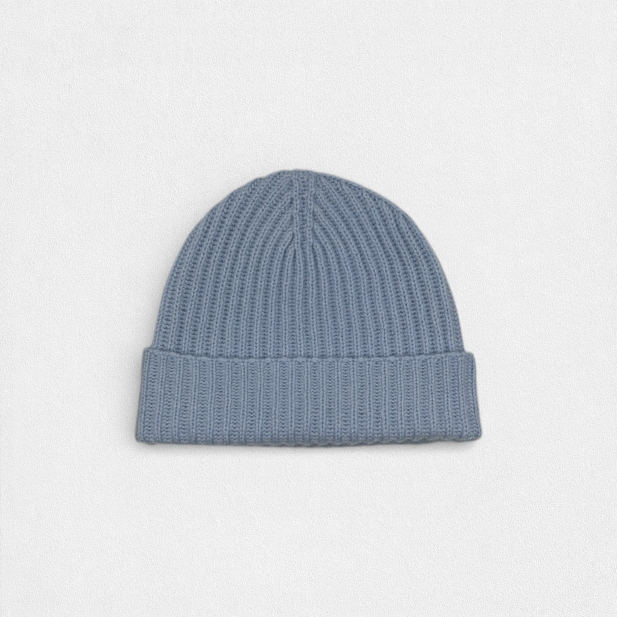Blue tone 100% cashmere ribbed beanie on a white background.