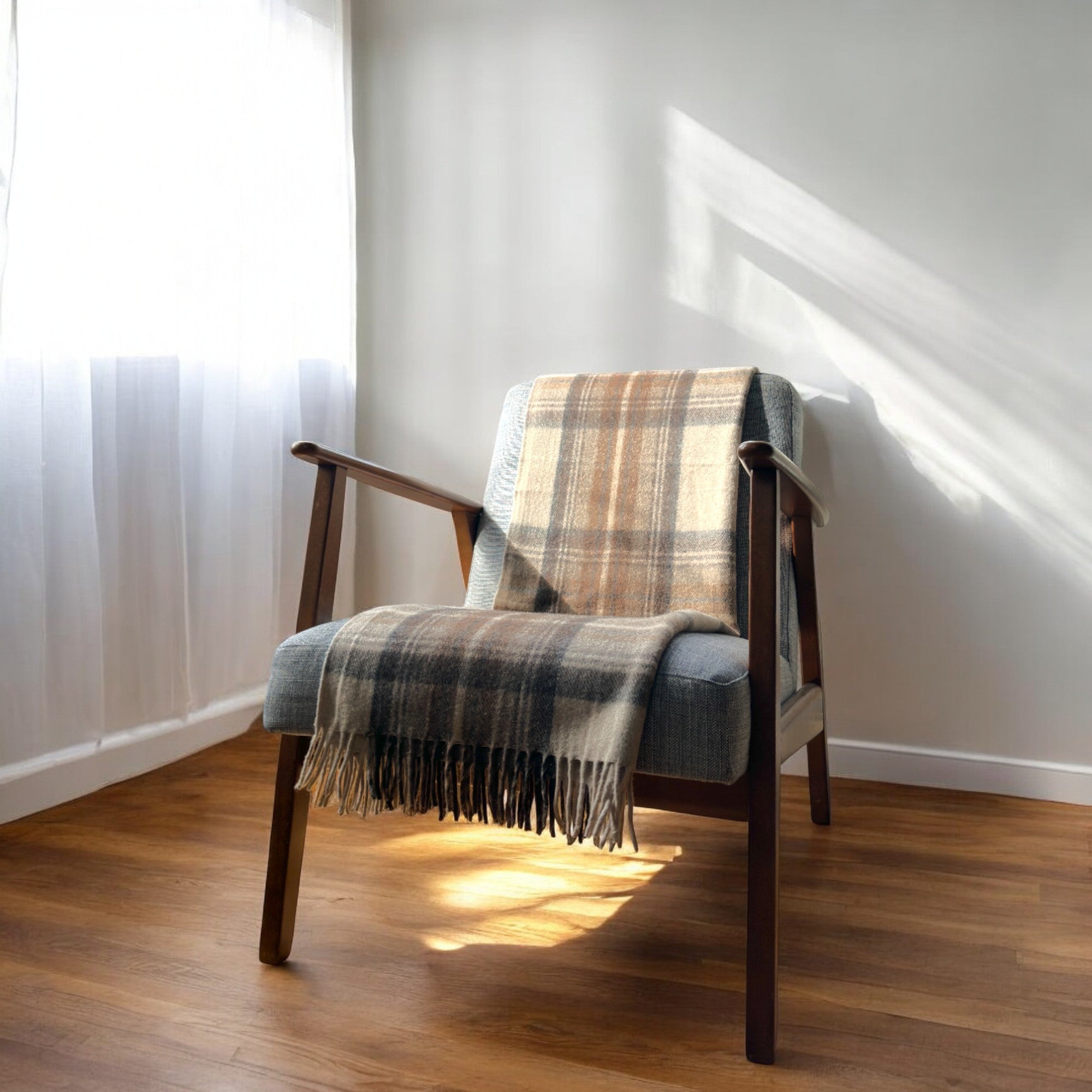 a natural dress 100% recycled knee blanket draped over a chair in a cosy room