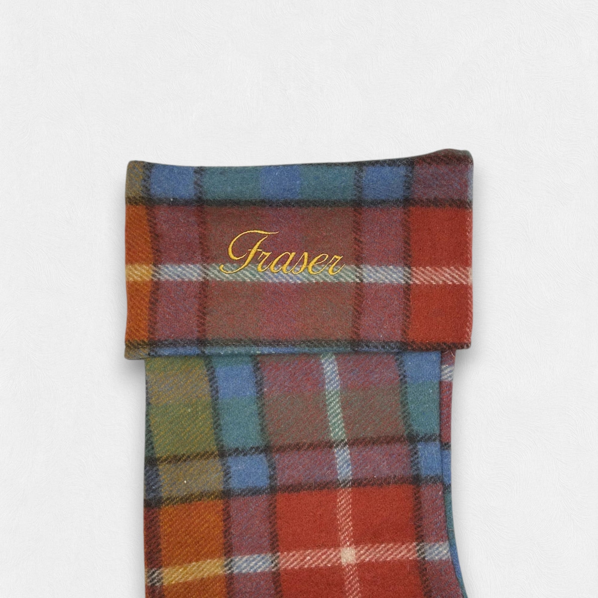 The word Fraser embroidered on the Antique Buchanan wool Christmas Stocking.