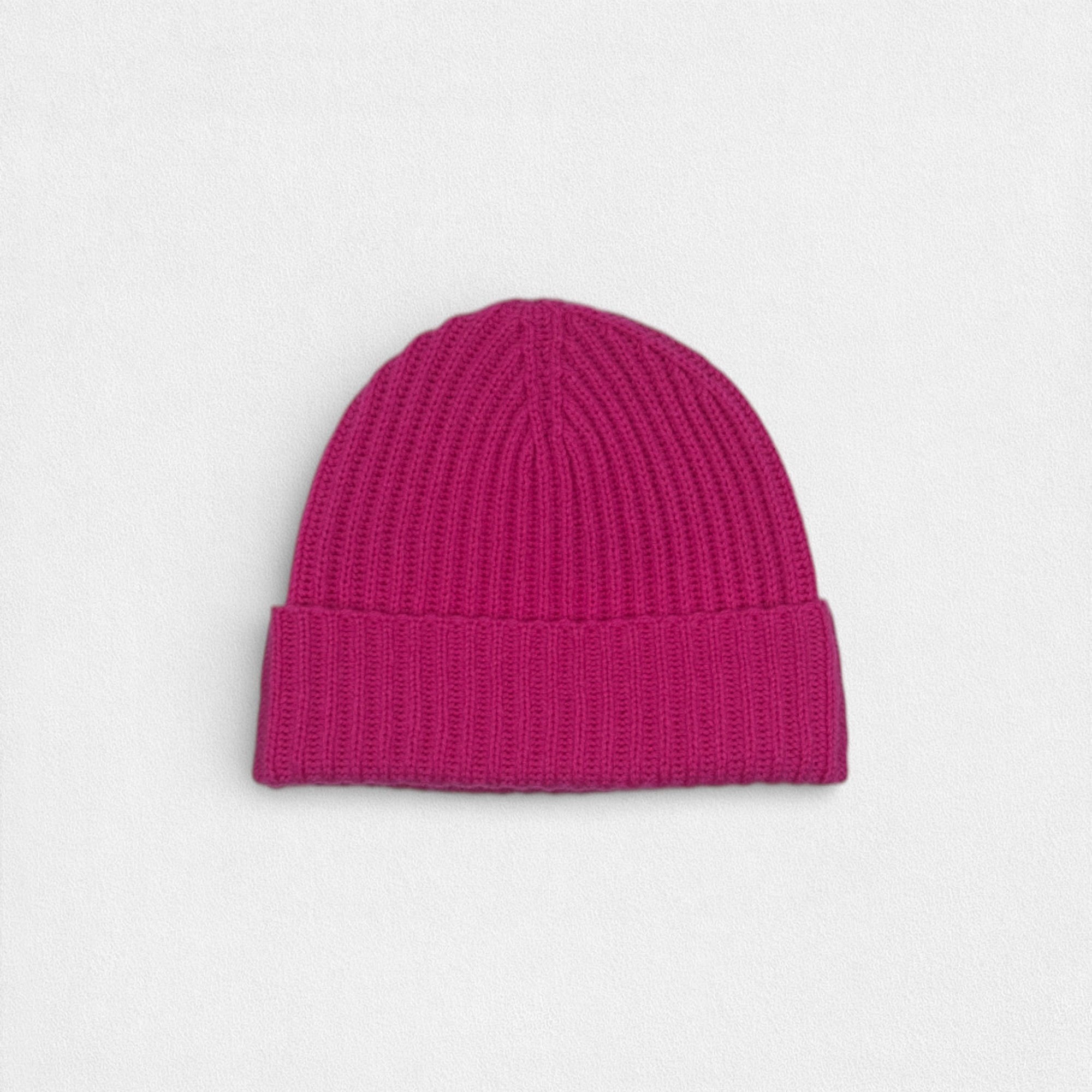 Pink knit beanie on a light gray background