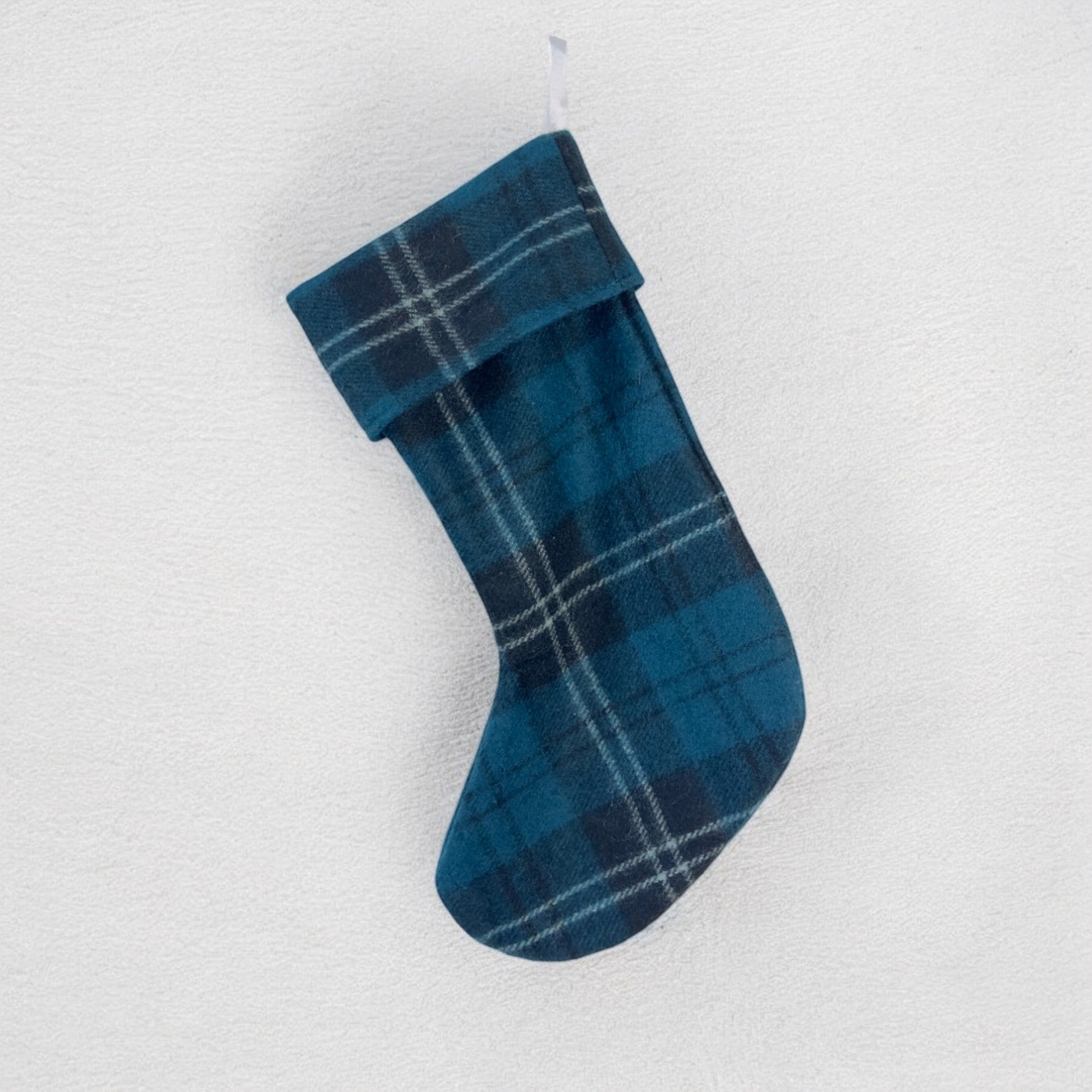 A blue and green plaid called Ramsay tartan Christmas stocking hanging against a white background.