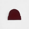 Red 100% cashmere beanie on a white background