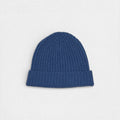 Blue knit beanie on a light gray background