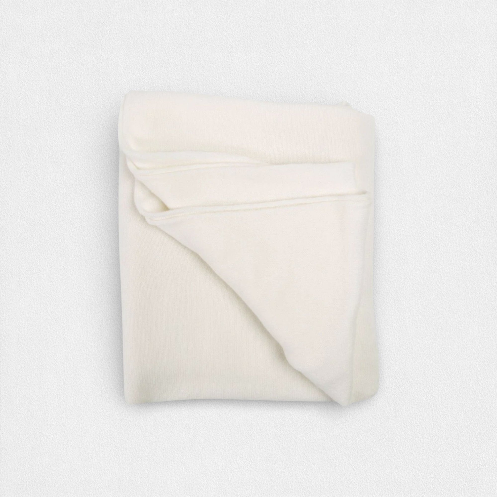 Folded white neck wrap on a light gray background