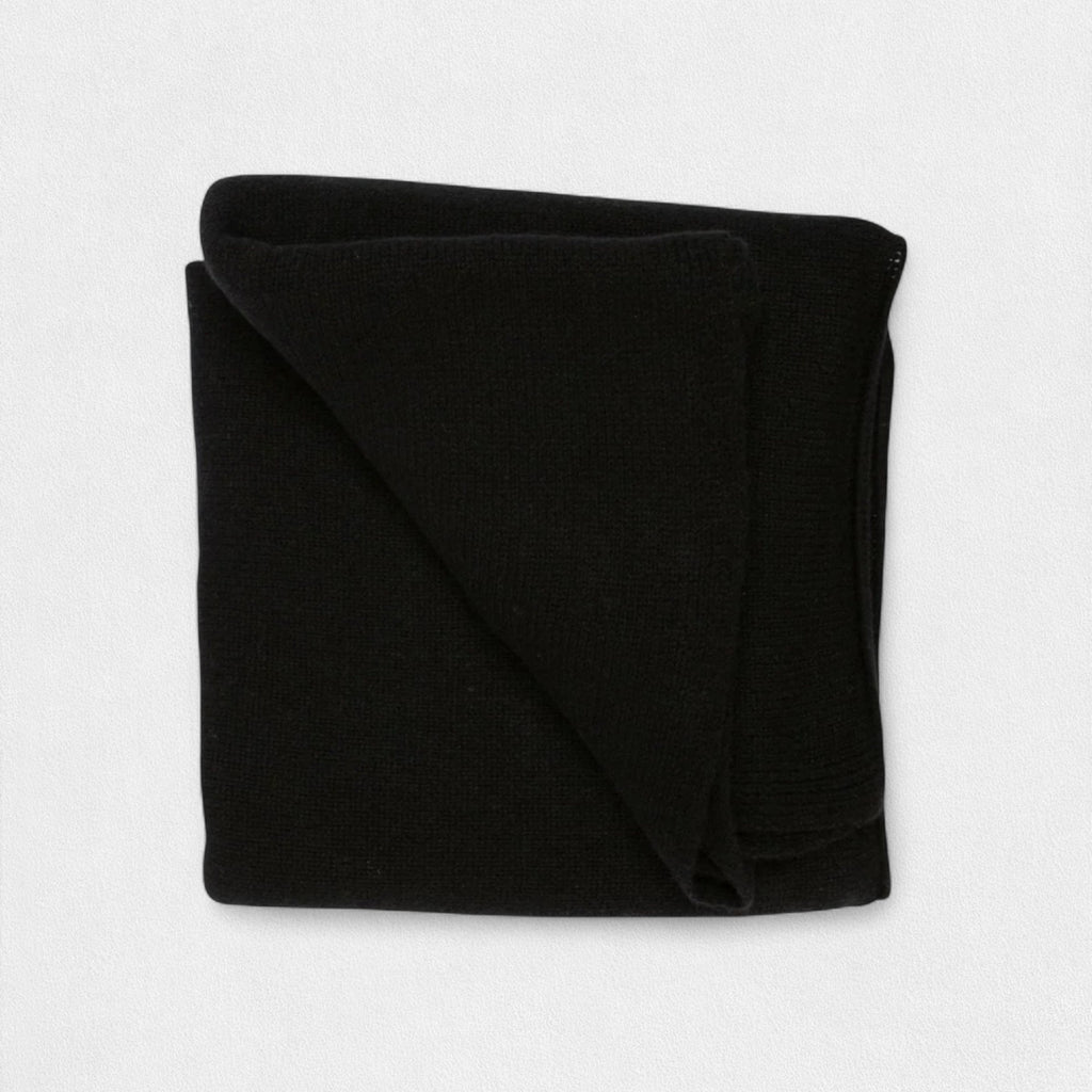 A folded black cashmere blanket displayed on a white background.