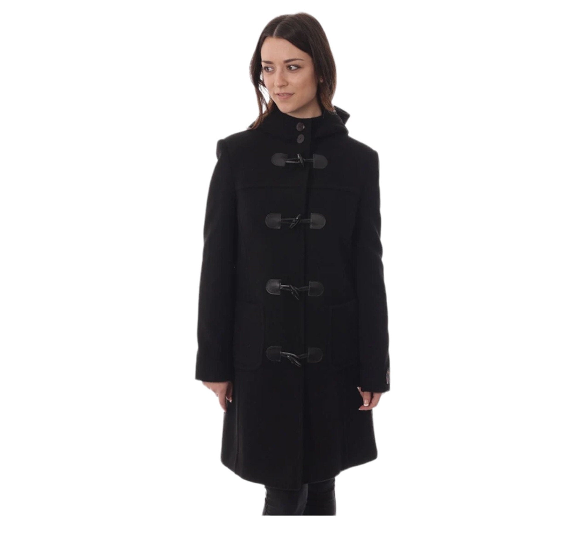 A woman standing outdoors wearing a black cashmere and wool duffle coat with a hood, featuring front pockets and classic toggles.